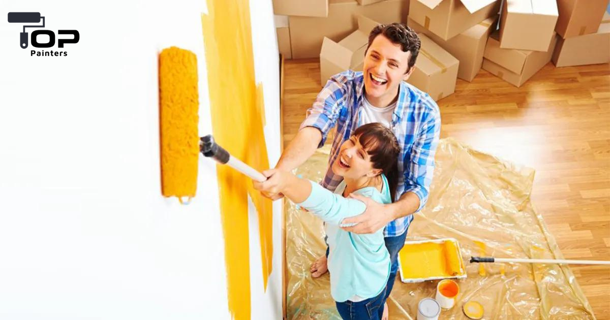 A couple painting their house