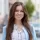 A woman with a sweet smile and long brown hair