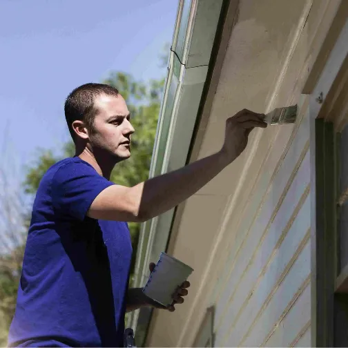 A painter do exterior painting with his brush