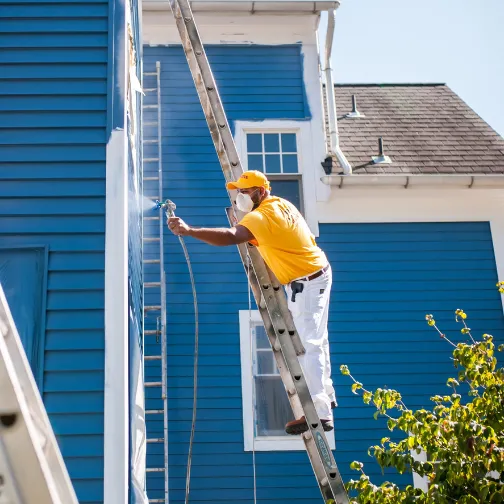 a painter spray pint to do exterior painting