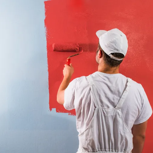 A man is painting the wall