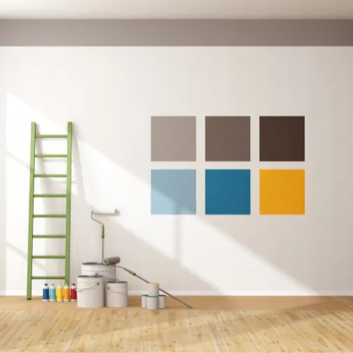Different colors on the wall next to painting tools